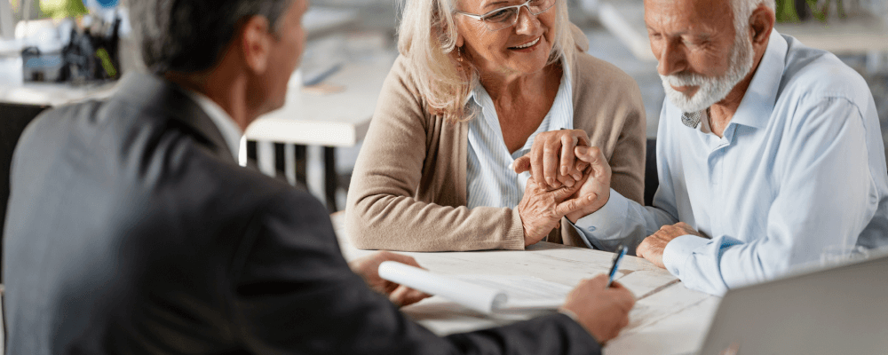 Older couple meeting with an attorney to fill out paperwork