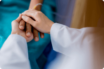 Doctor holds patients hand